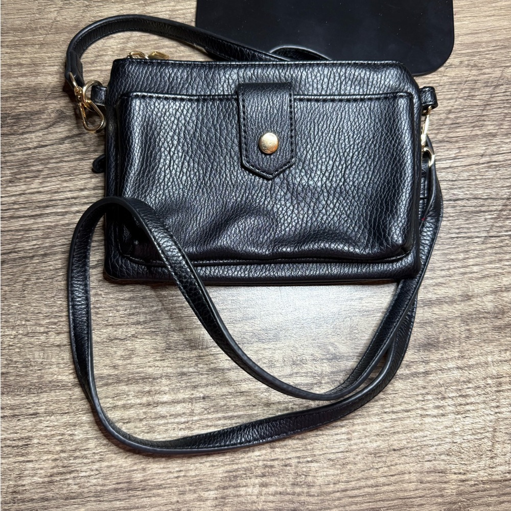 This is a black leather crossbody bag. Smoke free home.